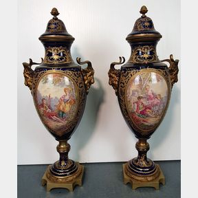 AN VERY FINE PAIR OF 19TH CENTURY SEVRES HAND PAINTED PORCELAIN URNS, decorated with picture panels to the fro