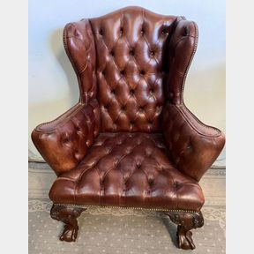 A VERY GOOD QUALITY BUTTON WING BACKED LEATHER ARM CHAIR, a charming piece of furniture, with brass beaded det