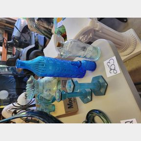 Blue bottles, candle sticks, and finger hole jug