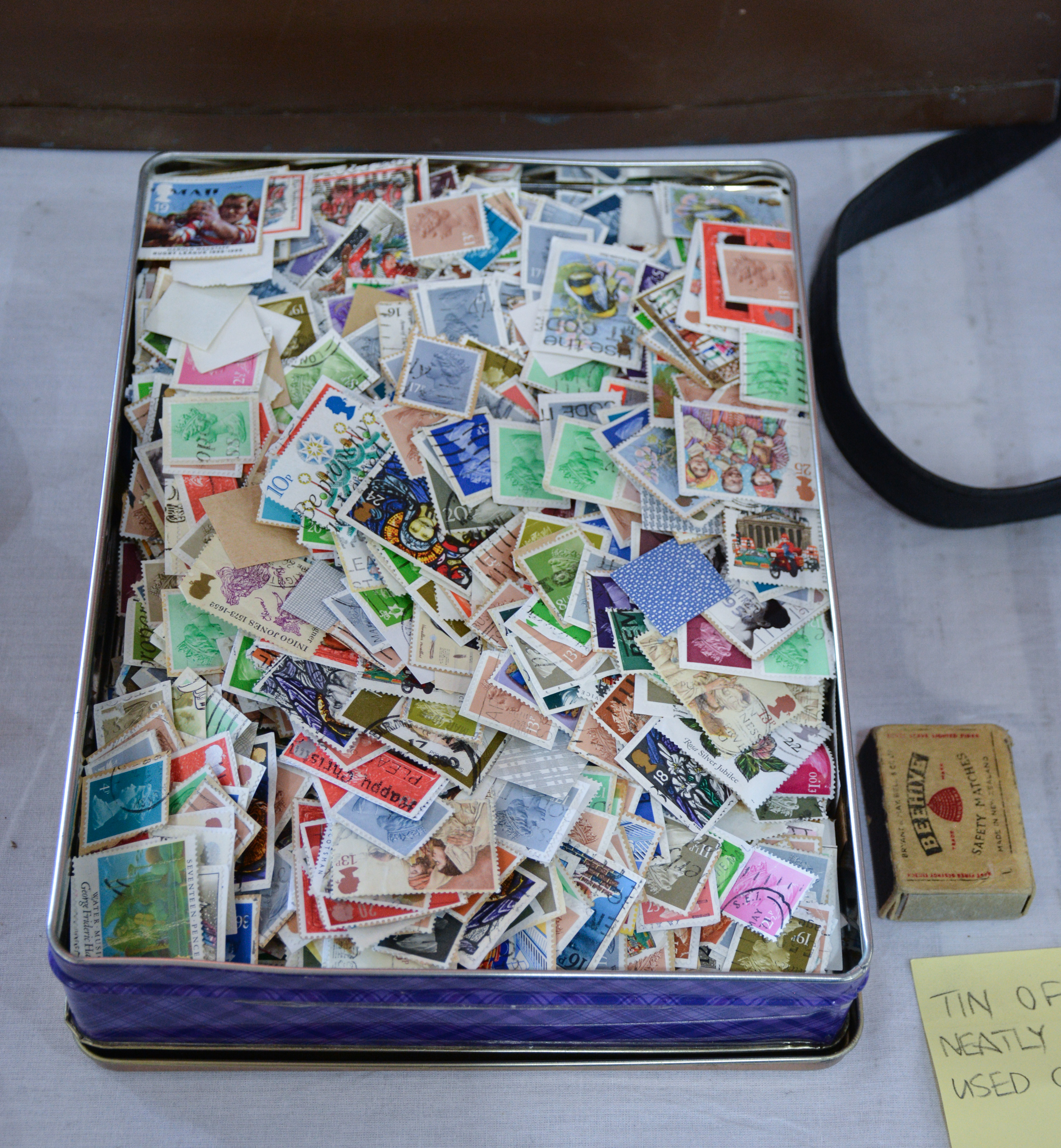 Tin of Neatly Trimmed Used Great Britain Stamps — sold at auction in New Zealand for $10