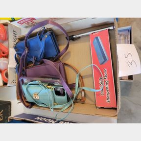 Assorted purses, phone covers, and sharpening stone
