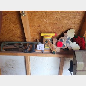 Reindeer, saw and other items on wall and shelf