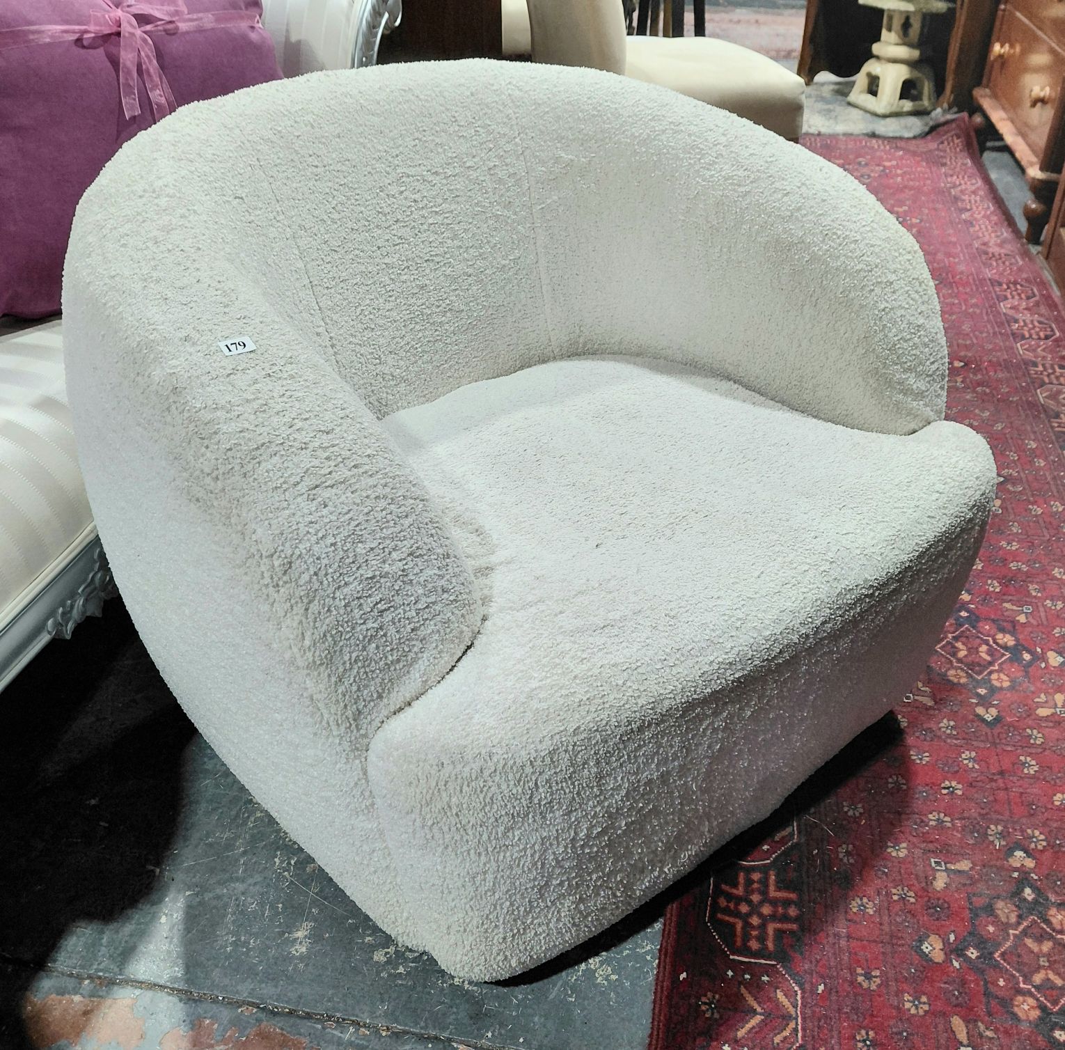 179 · A BOUCLE UPHOLSTERED ARMCHAIR