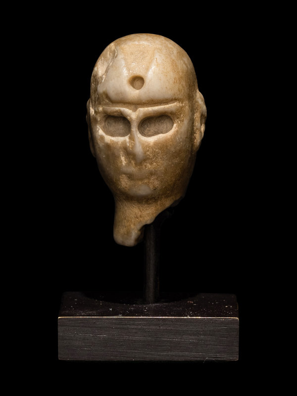 A Sumerian Stone Head
Height 13/32 inches (1 cm). 