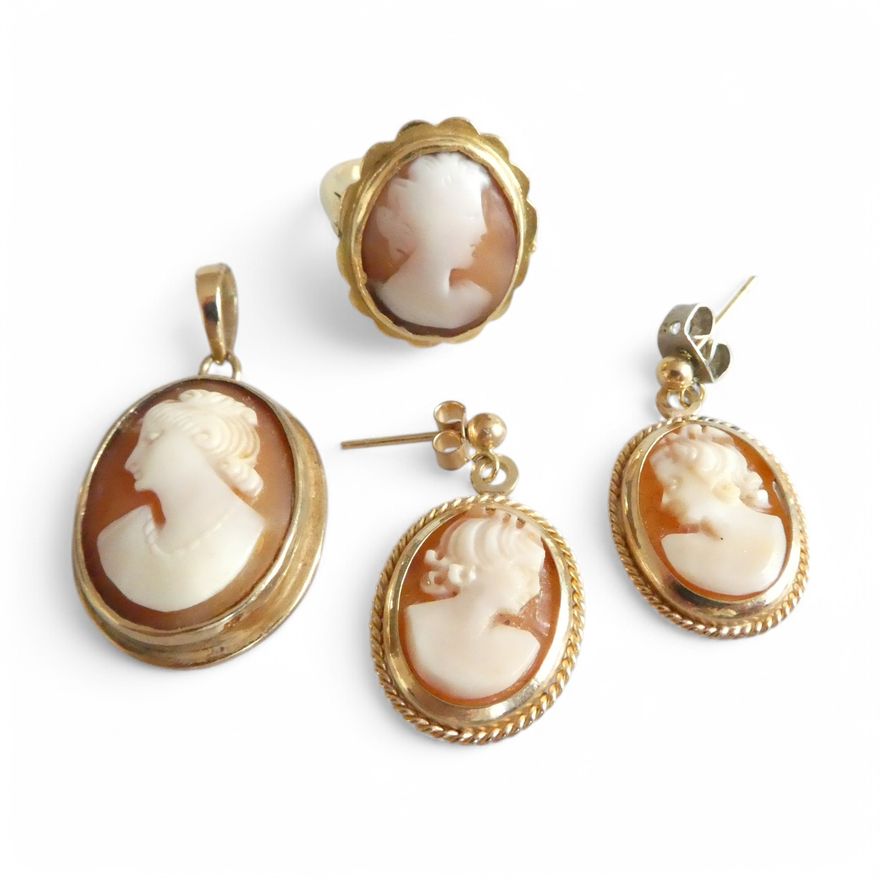 A shell cameo set, comprising a pair of earrings, ring and pendant