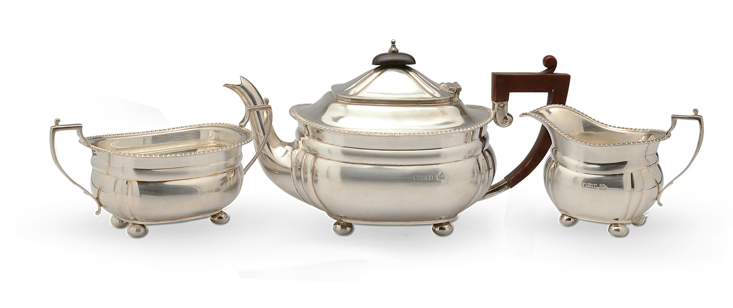 A silver three piece tea set