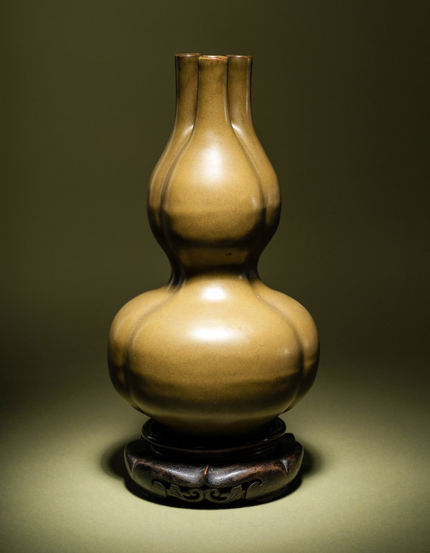 A Teadust Glazed Porcelain Triple-Neck Gourd Vase
Height 9 1/2 in., 24.1 cm.