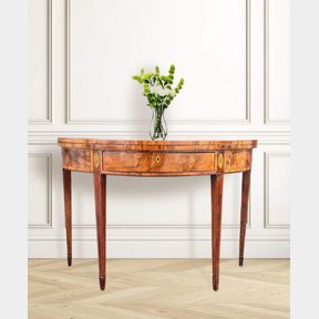 A LATE 18TH CENTURY GEORGIAN MAHOGANY DEMI-LUNE FOLD OVER TEA TABLE, with fantastic satinwood cross-banded top