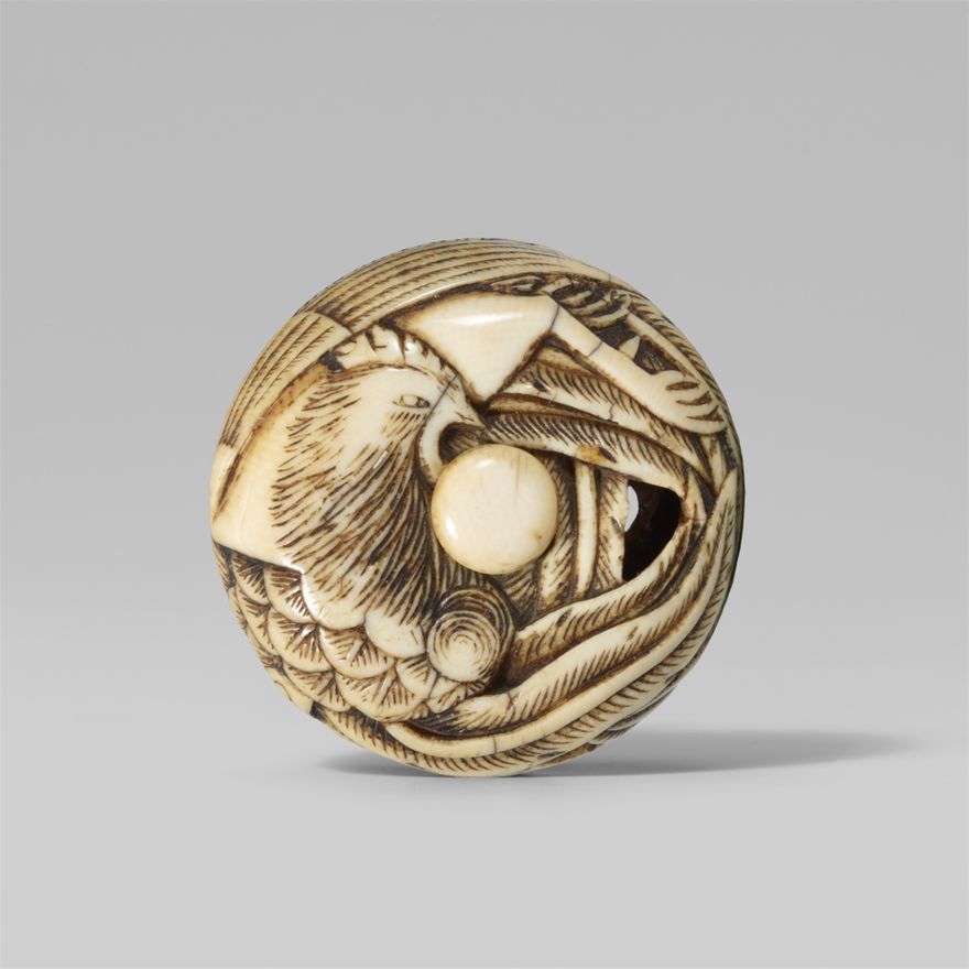 An ivory peg ryusa manju of a long-tailed phoenix. Mid-19th century