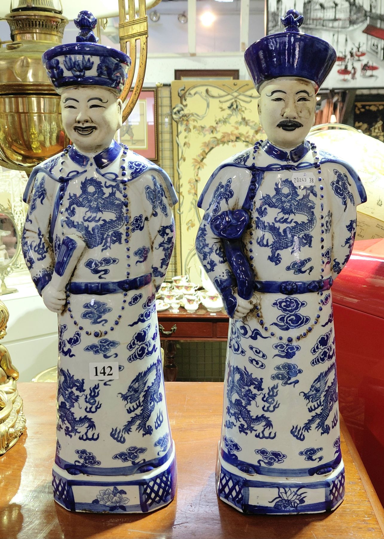 142 · TWO ORIENTAL FIGURAL ORNAMENTS