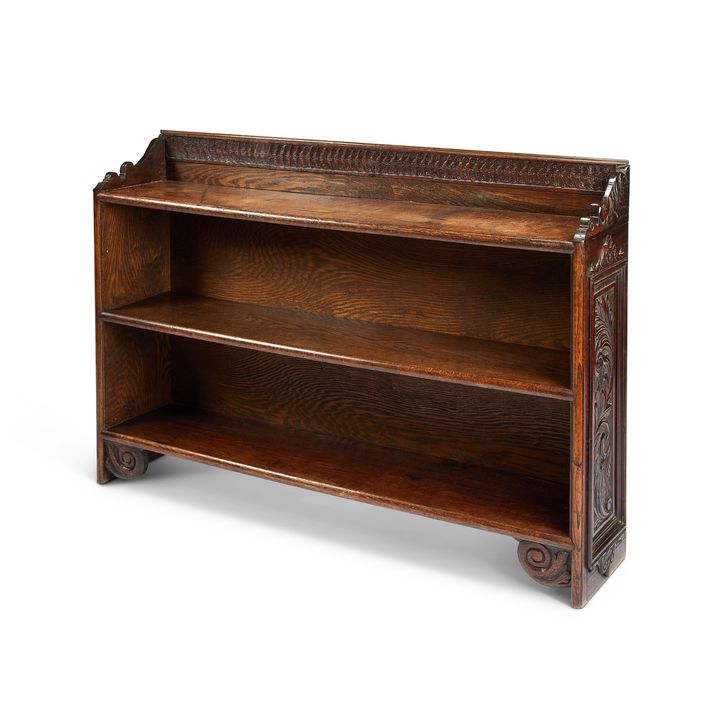 A Victorian carved oak low open bookcase