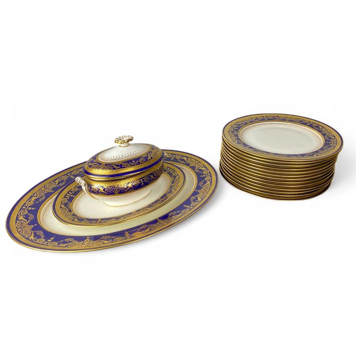 An early 20th century Wedgwood cobalt blue and gilt part dinner service retailed by Mortlocks of Oxf