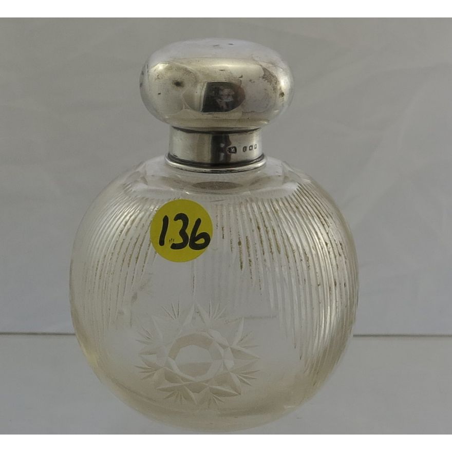 AN EARLY 20TH CENTURY SILVER COVERED GLASS SCENT BOTTLE.