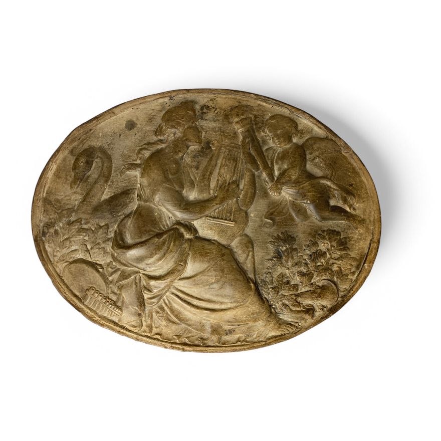 A 19th century neo-classical style oval terracotta wall plaque depicting Erato and Cupid