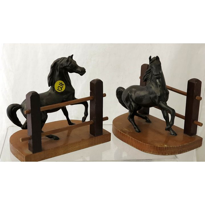 A PAIR OF 20TH CENTURY SPELTER MOUNTED WOODEN BOOKENDS.