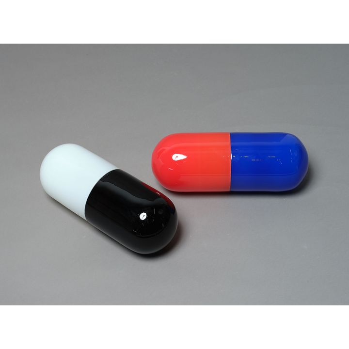 A pair of decorative glass pills