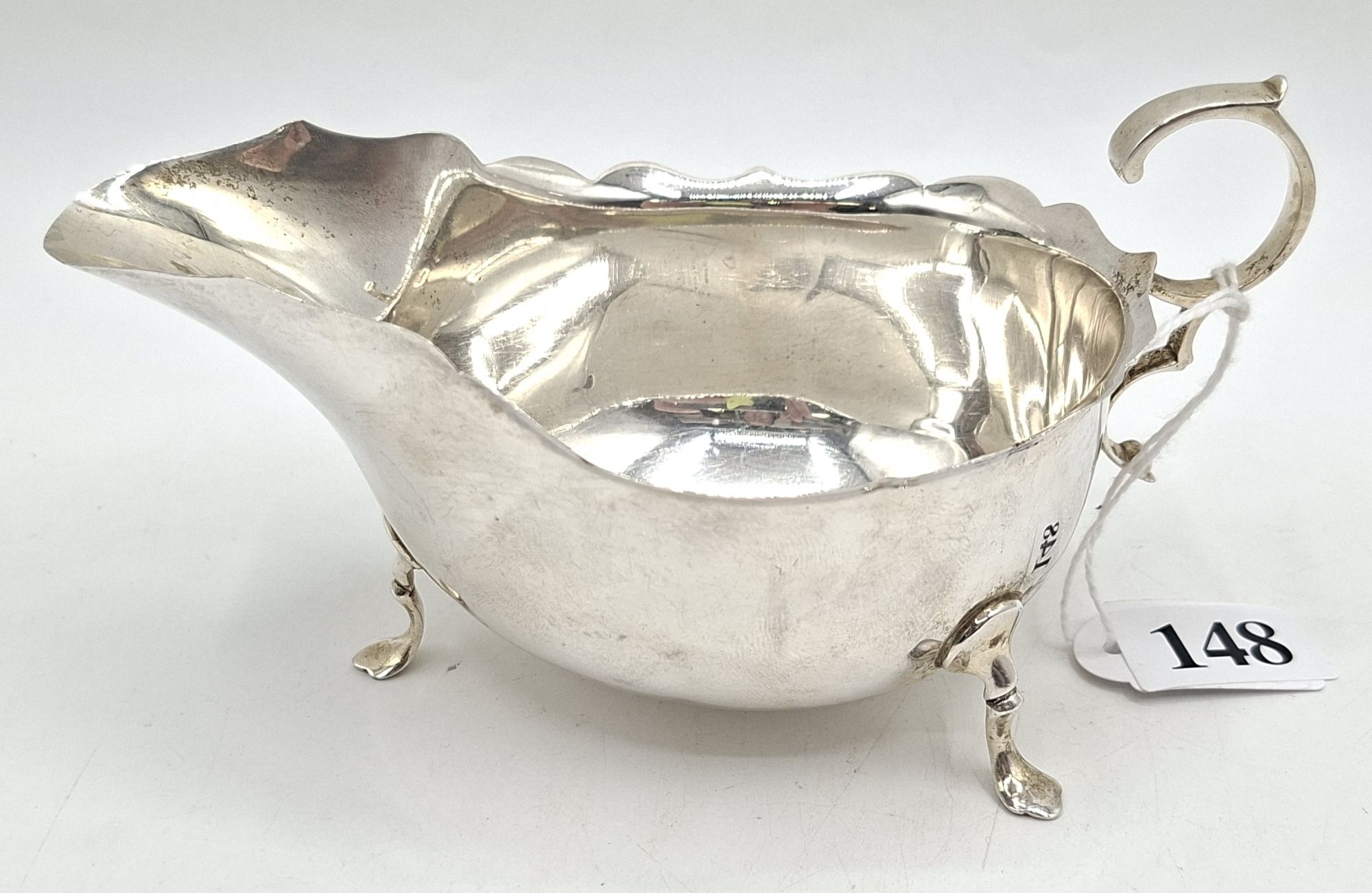 148 · A STERLING SILVER GRAVY JUG