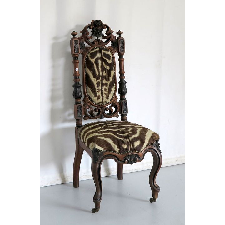 CARVED AND UPHOLSTERED SIDE CHAIR on castors