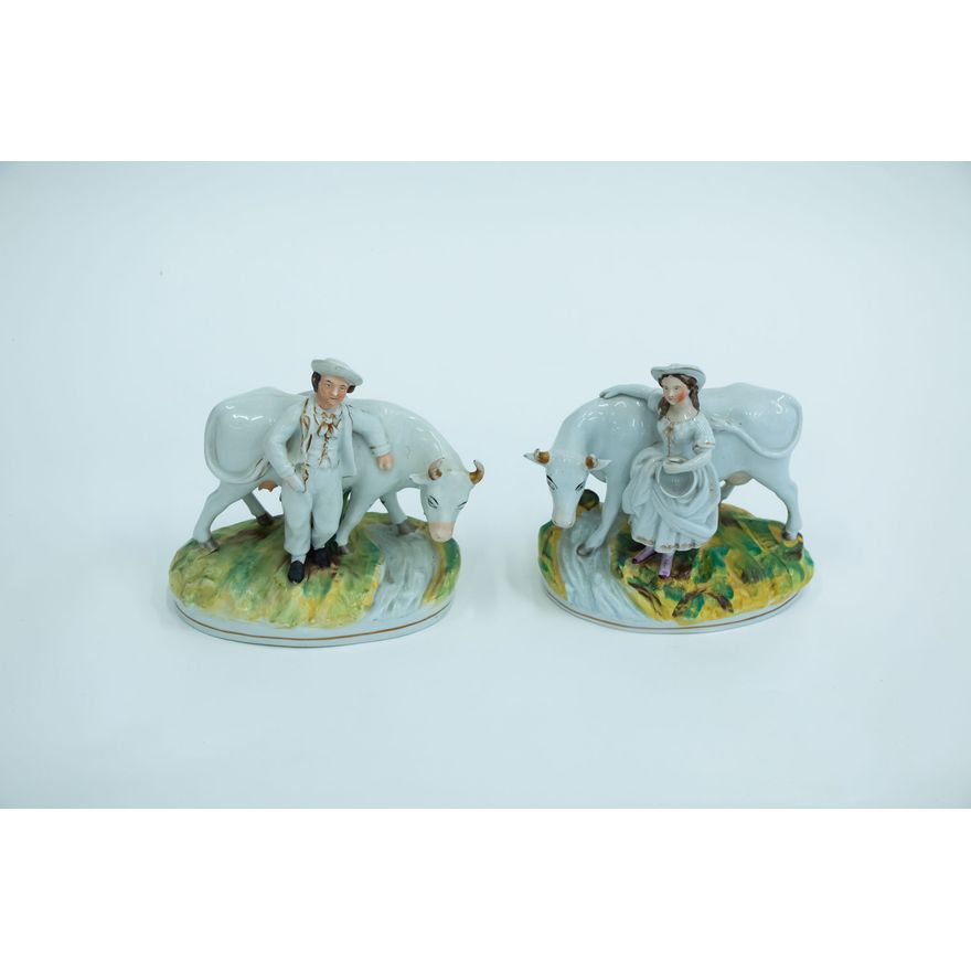 A pair of mid-19th-century Staffordshire milkman & milkmaid figures