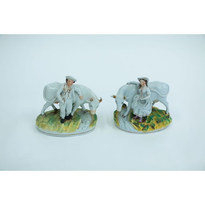 A pair of mid-19th-century Staffordshire milkman & milkmaid figures