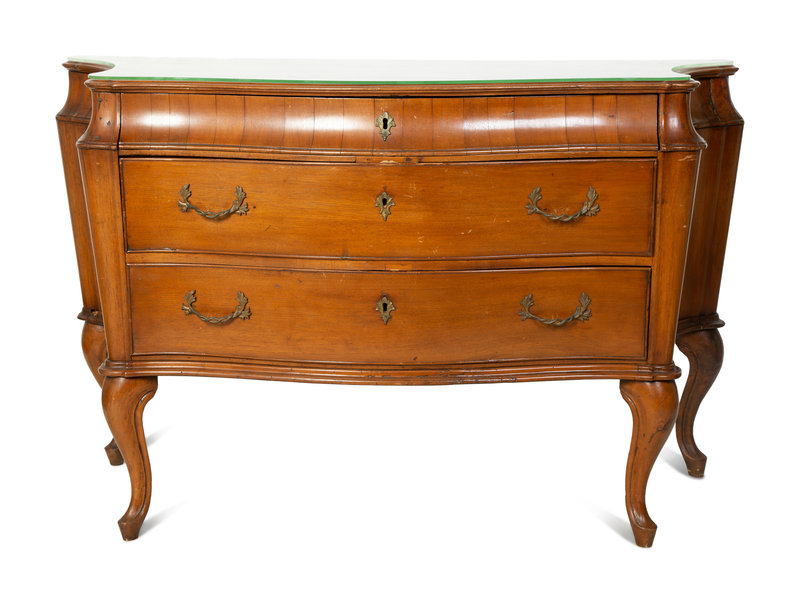 An Italian Louis XV Style Olive Wood Bombe Commode
Height 35 1/4 x width 54 1/2 x depth 22 1/2 inches.