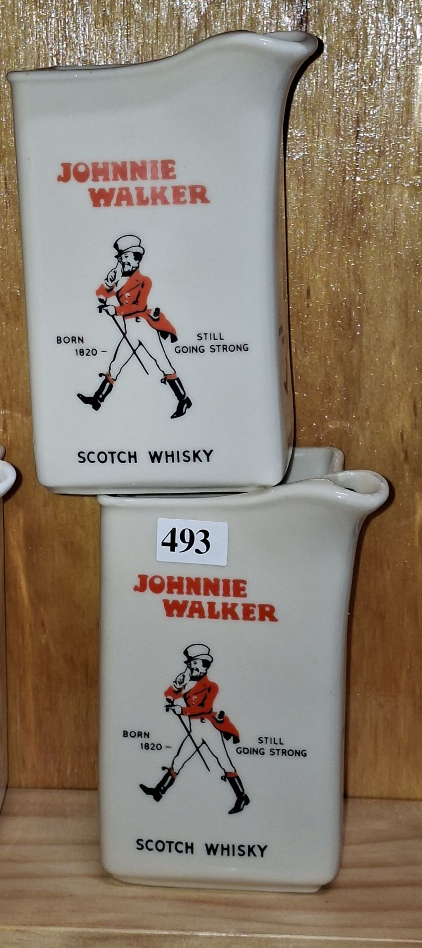 A PAIR OF HUNTLEY WARE JOHNNIE WALKER JUGS