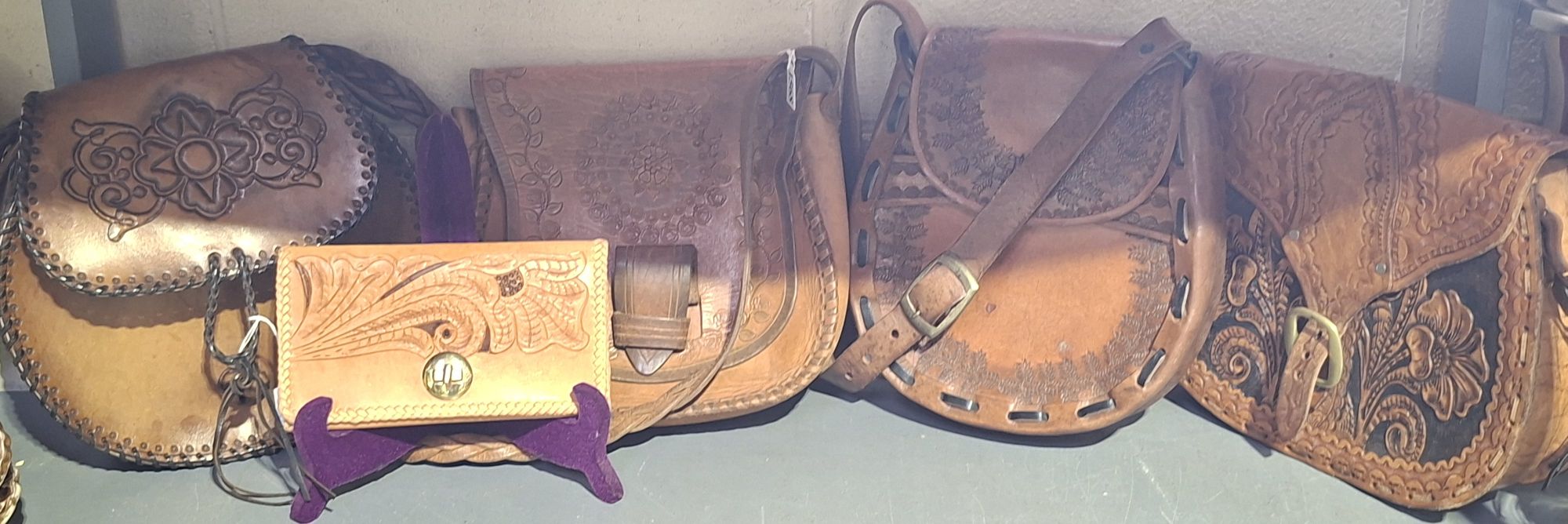 FIVE VINTAGE TOOLED LEATHER ITEMS