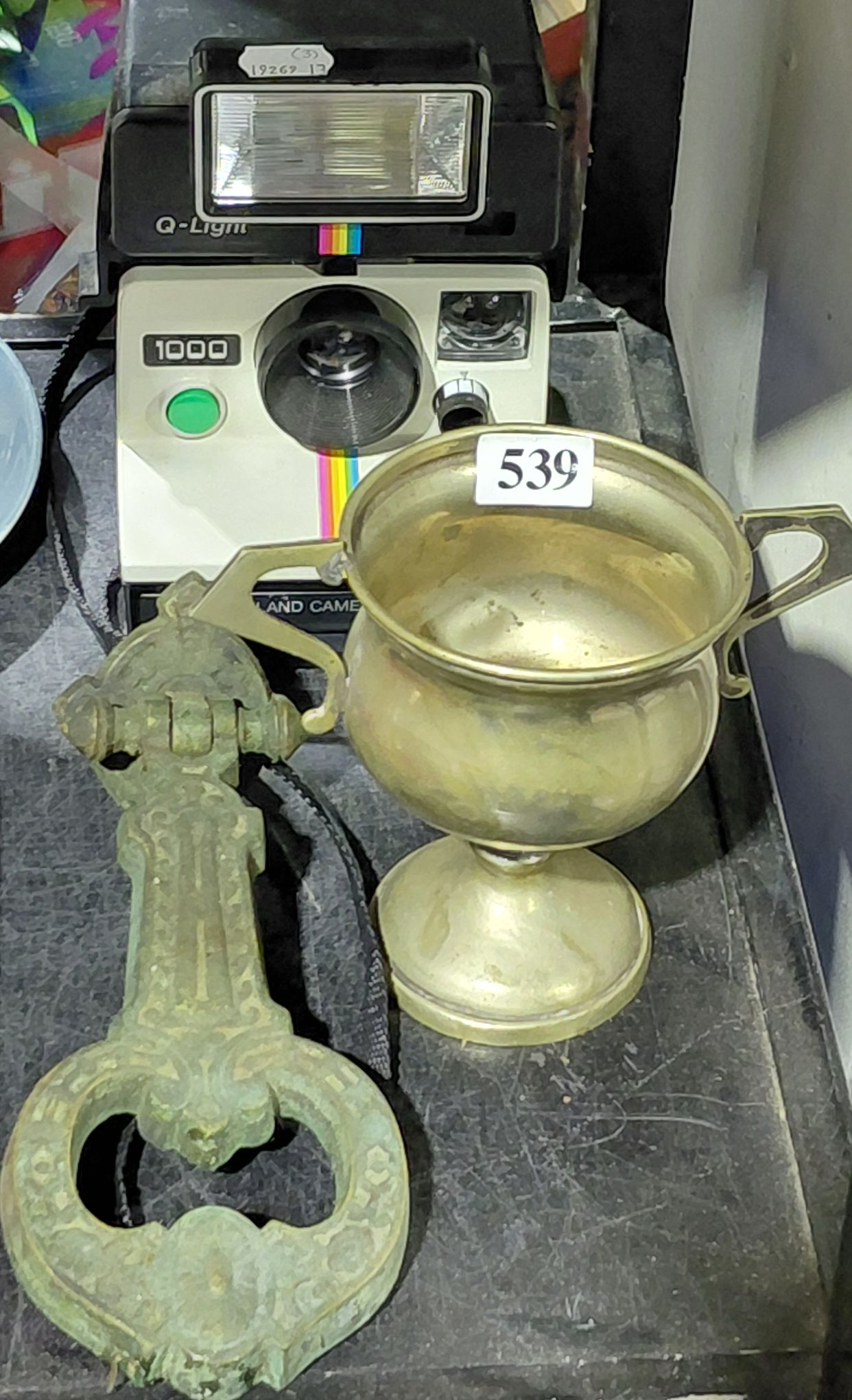 Trophy Cup, Polaroid Camera And Door Knocker