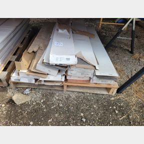 Pallet of various colors and styles of laminated flooring