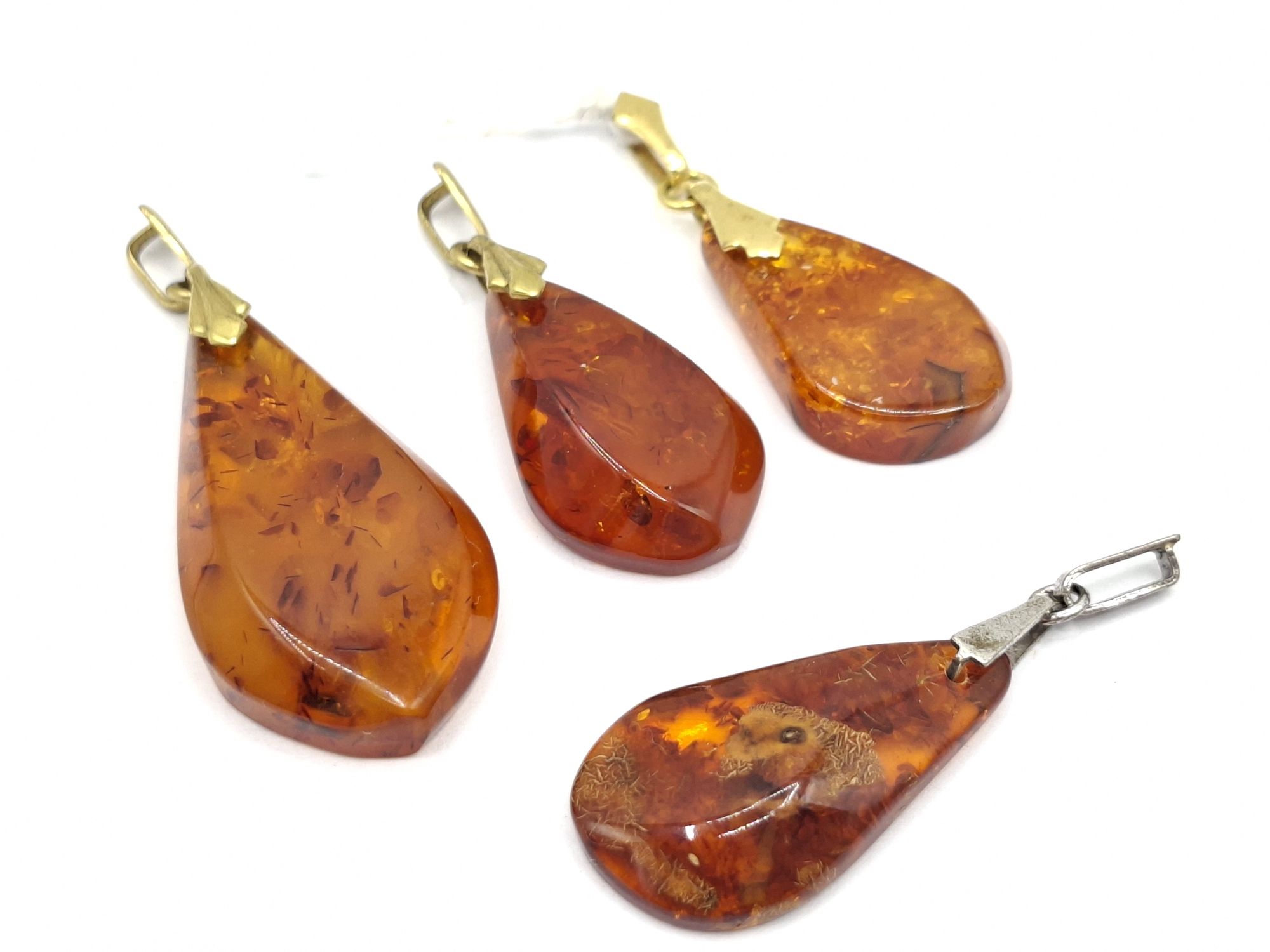 1057 · FOUR AMBER PENDANTS
