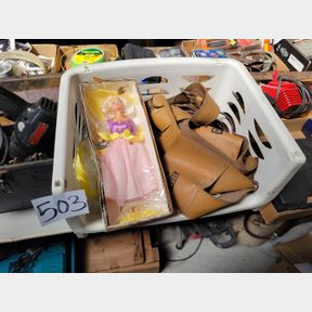 Plastic container with Barbie Doll, extension cords and other