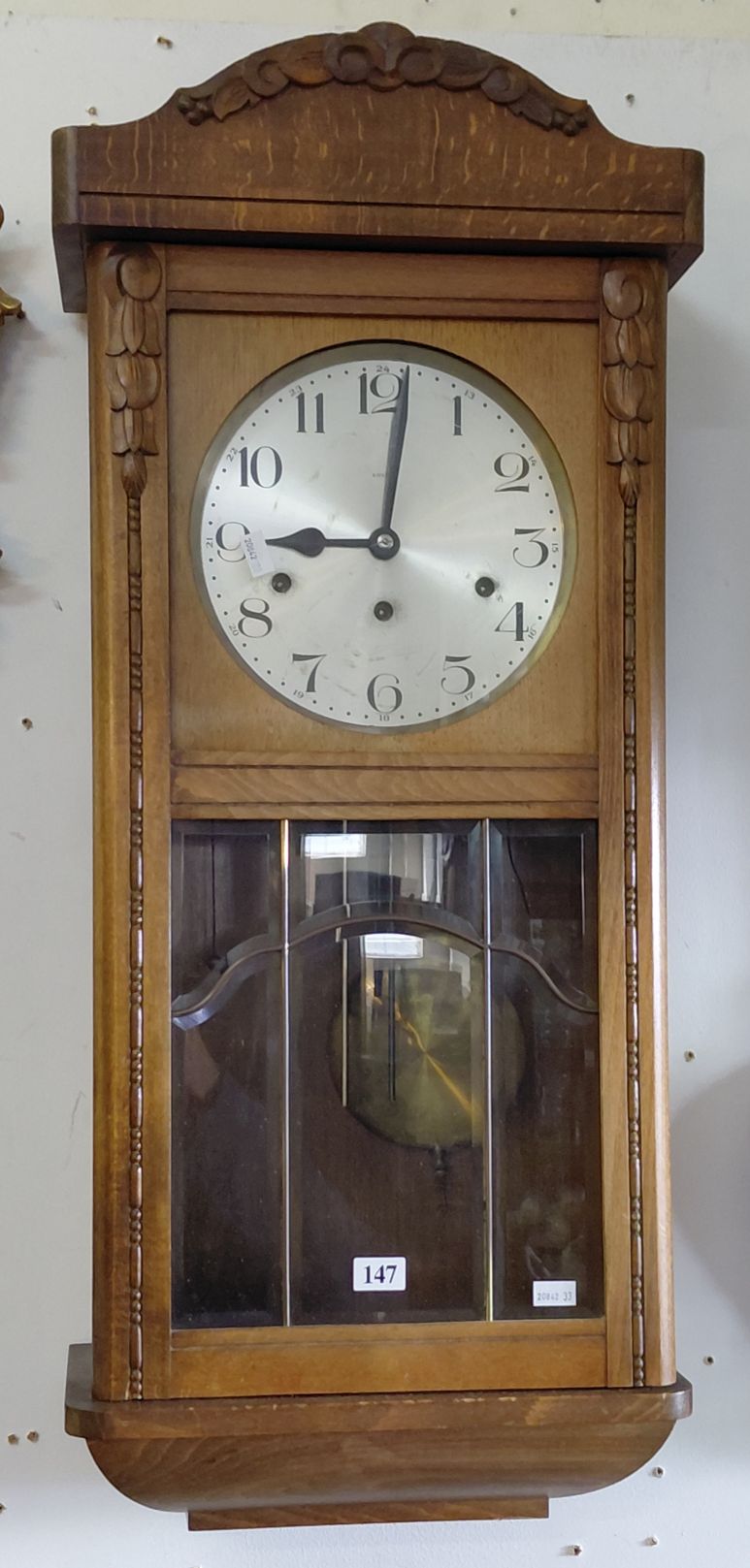 AN OAK CASED WALL CLOCK