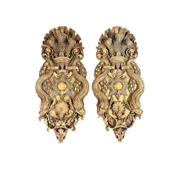 A pair of large and unusual 19th century giltwood wall carvings after a design by William Kent for t