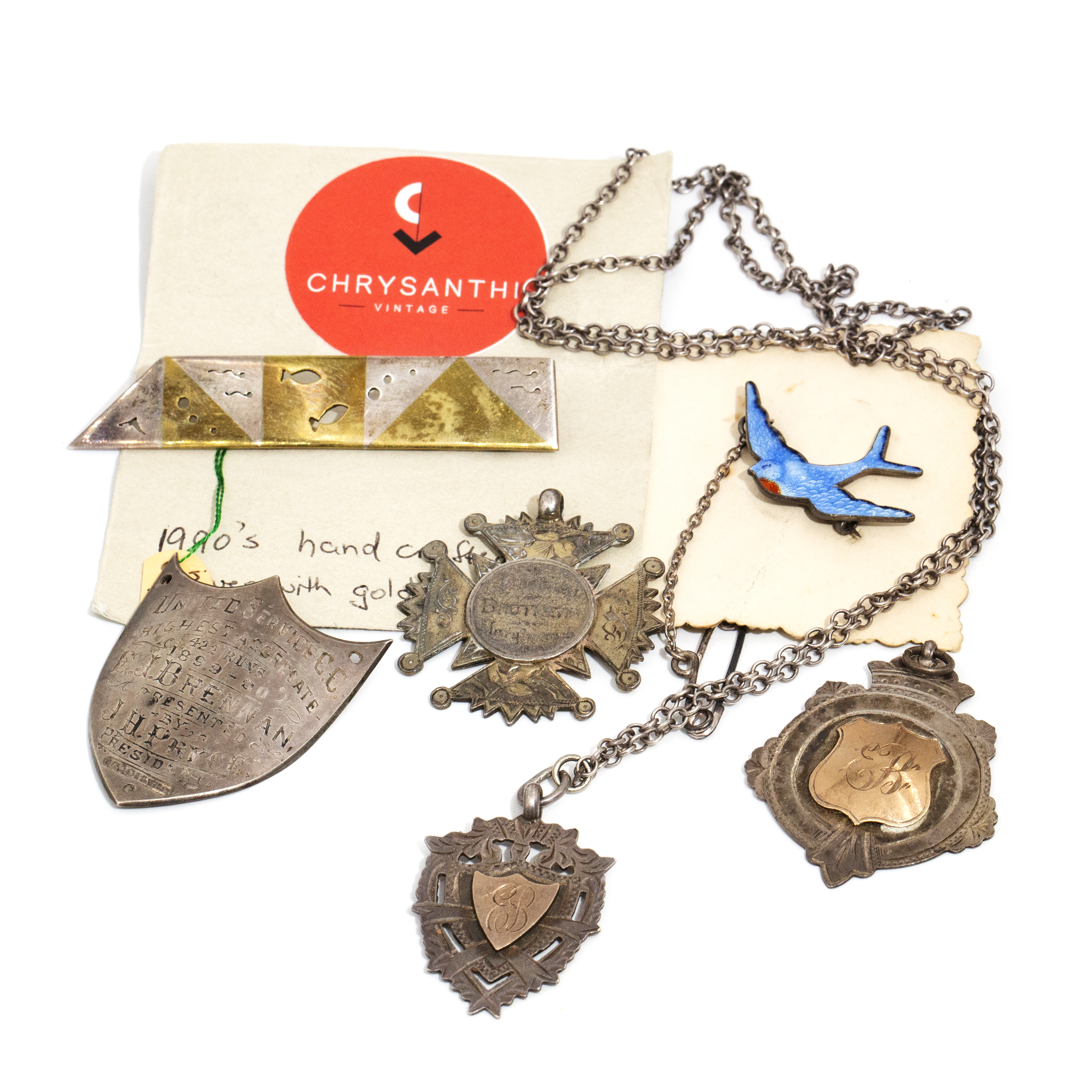 417 · Four Silver Shield Pendants, Two Silver/Gold Brooches