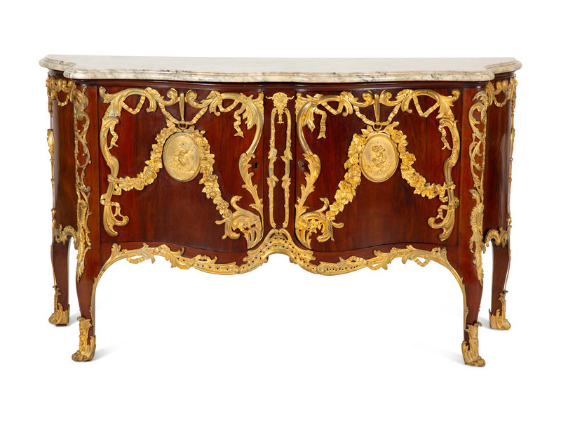 A Régence Style Gilt Bronze Mounted Mahogany Marble-Top Commode
Height 37 1/2 x width 65 x depth 23 1/2 inches.
