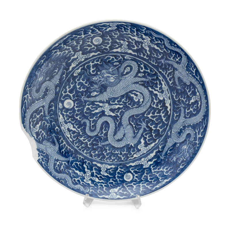 A Large Reverse-Decorated Blue and White Porcelain Charger
Diameter 18 3/4 in., 47.6 cm.