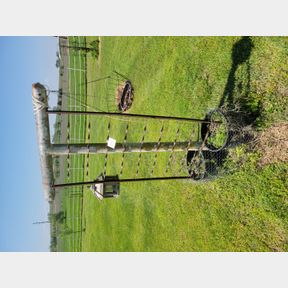 Porch rail, bird feeder, basket and trellis by the clothes racks