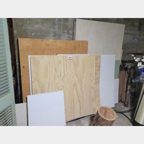 Assortment of lumber supplies, saw horses, everything on ceilings and shelves