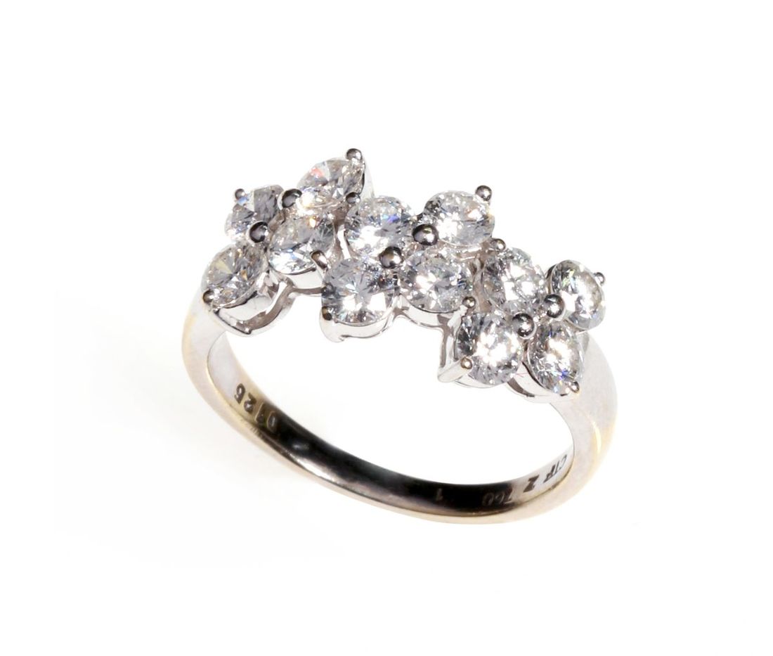 Jewellery, an 18k white gold ring set with 12 diamonds, | Spink