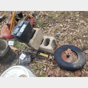 Various scrap metals, car jack and concrete block