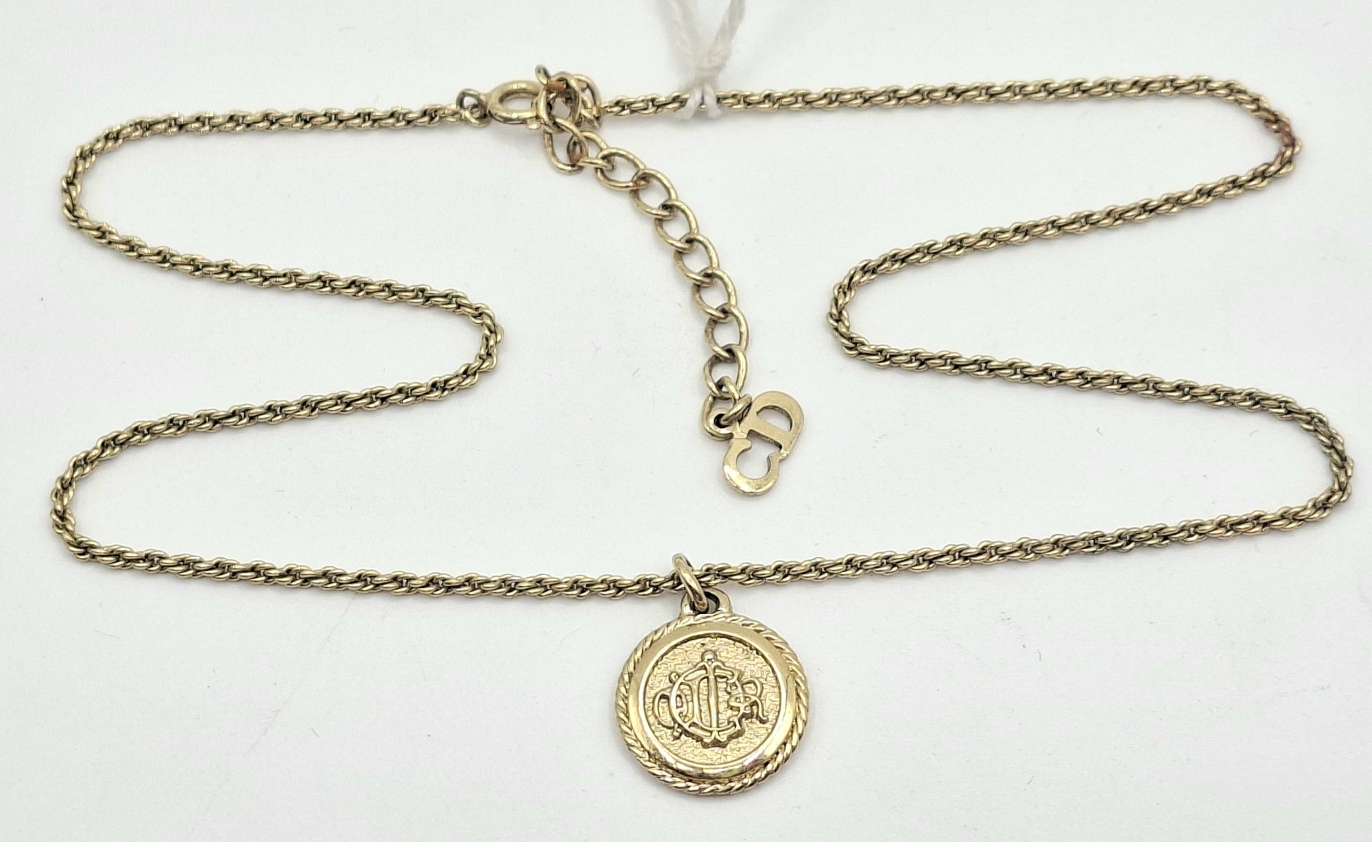 1083 · CHRISTIAN DIOR MONOGRAMMED ROUND PENDANT