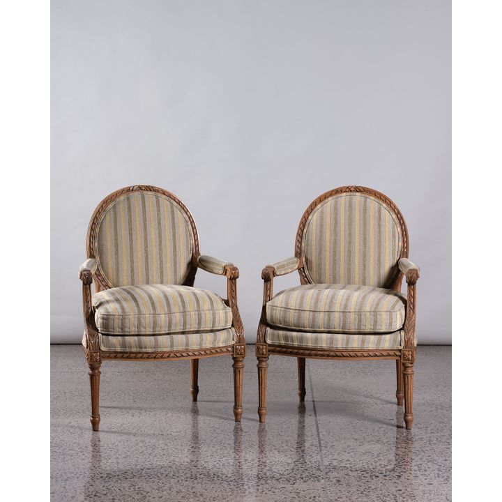 A pair of French carved armchairs