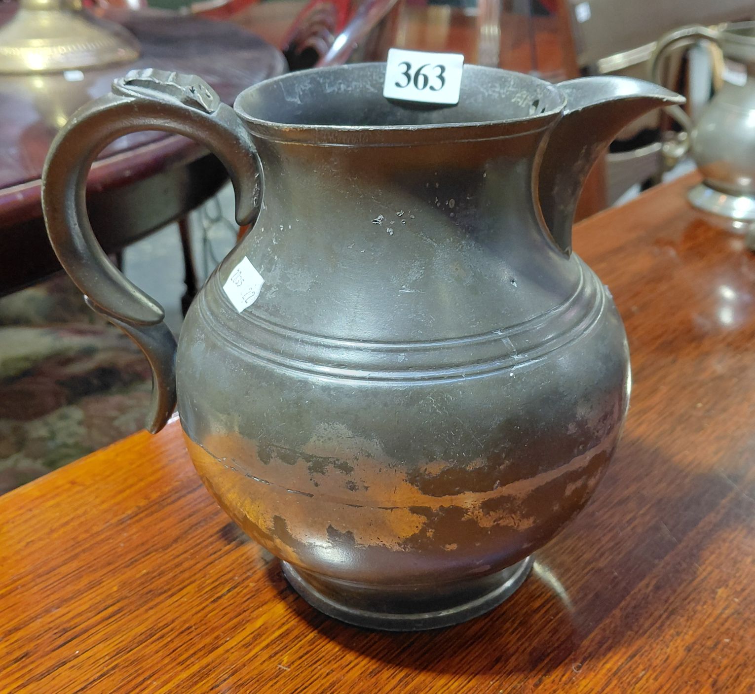 A PEWTER BULBOUS ALE JUG