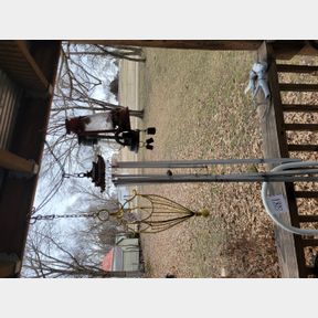 Small oil lanterns, windchimes and decorative basket on the porch