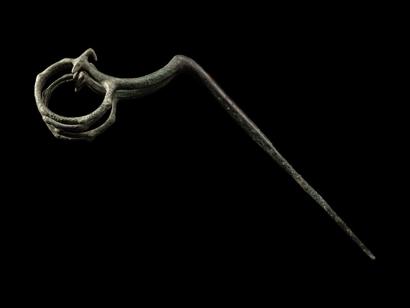 A Luristan Bronze Ibex Fibula
Height 11 inches (27.9 cm).