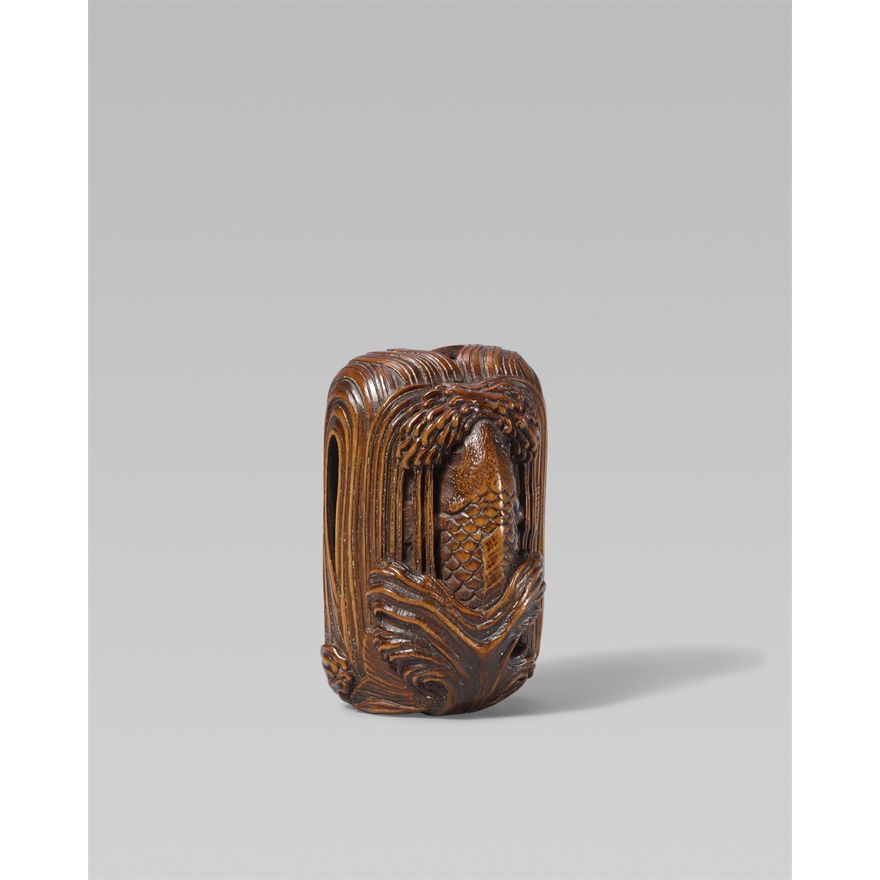 A large boxwood netsuke of a carp leaping up a waterfall. Early 20th century