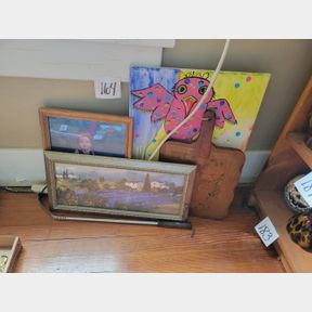 Assorted artwork pieces and wood handled board