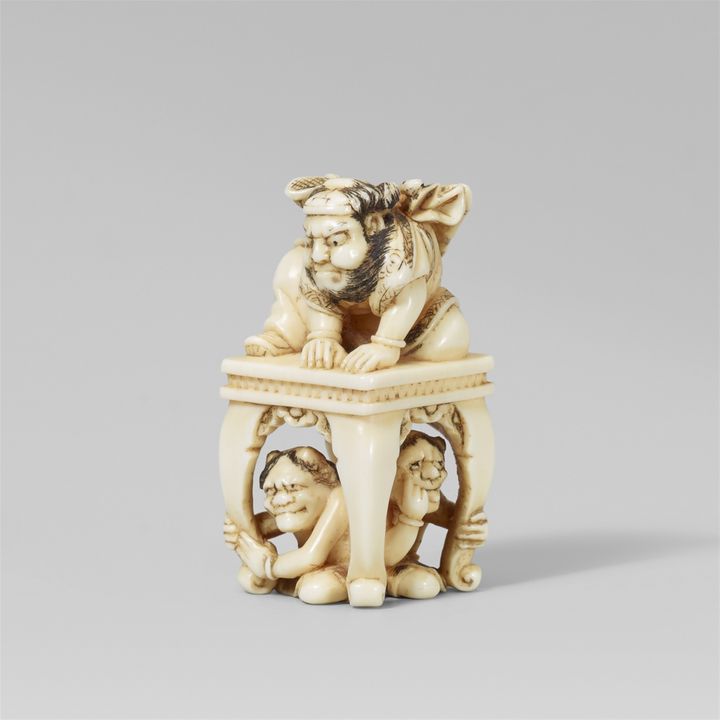 An ivory netsuke of Shoki with two oni. Mid-19th century