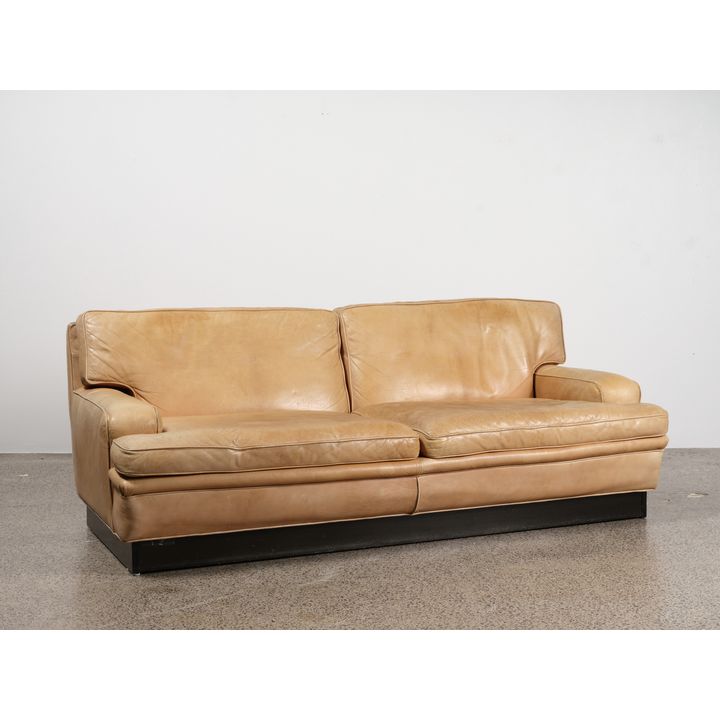 A generously proportioned two-seater leather sofa by Arne Norell