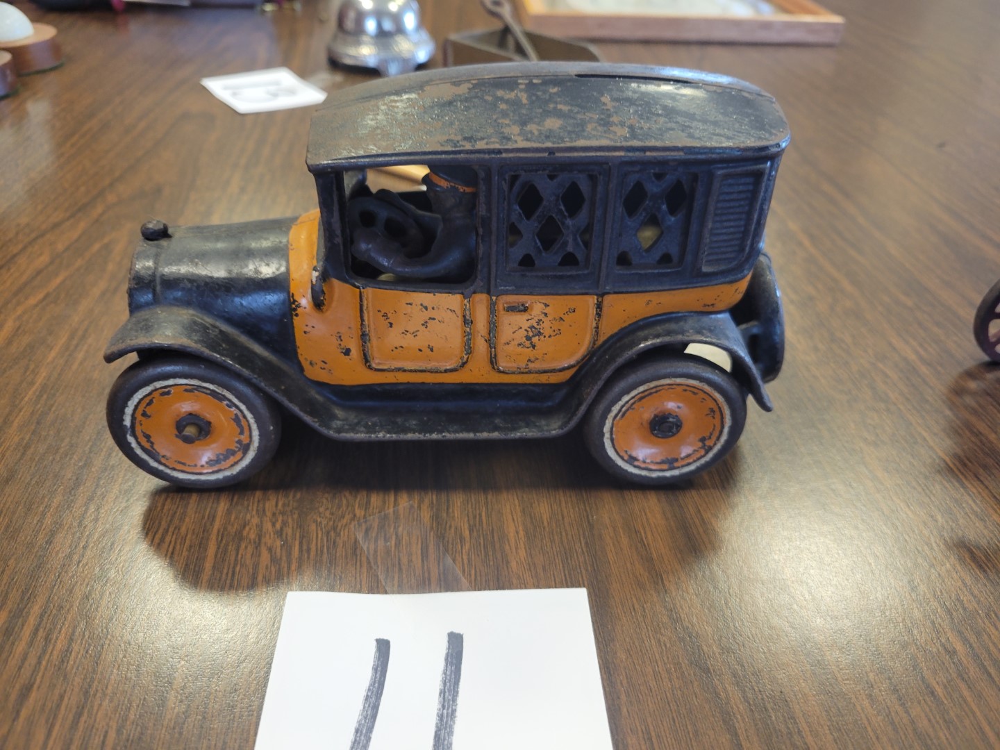 Antique Cast iron car bank with driver | Midwest Auctions, LLC